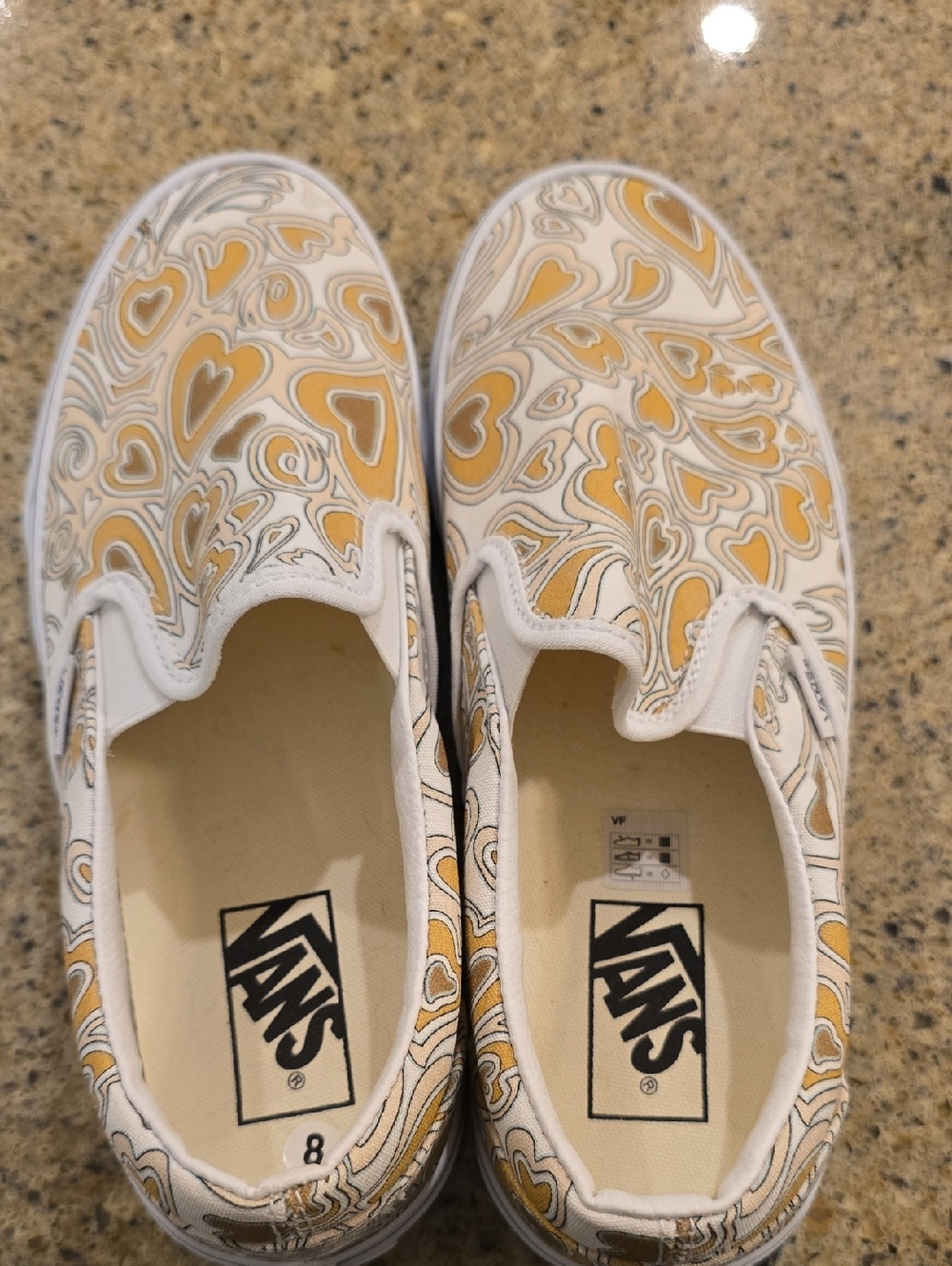 Vans White Canvas Slip-Ons with Yellow Heart Swirl Print